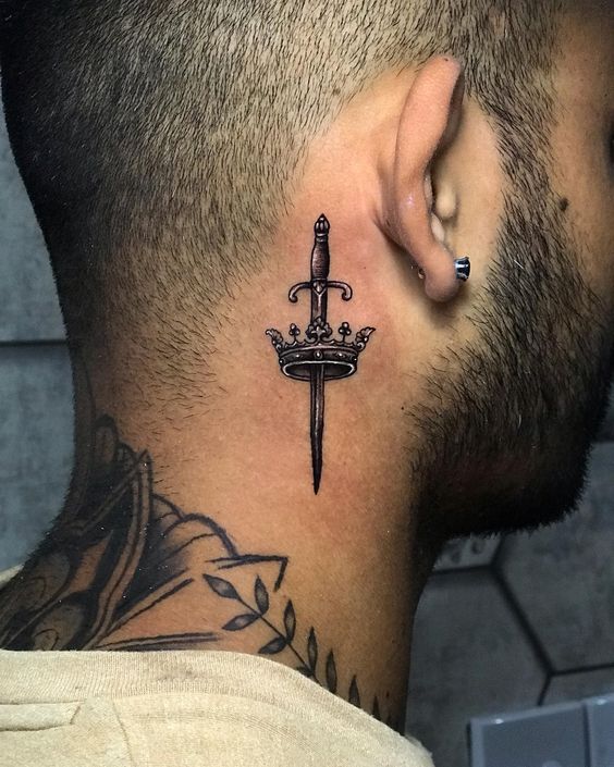 Sword behind the ear tattoo for men
