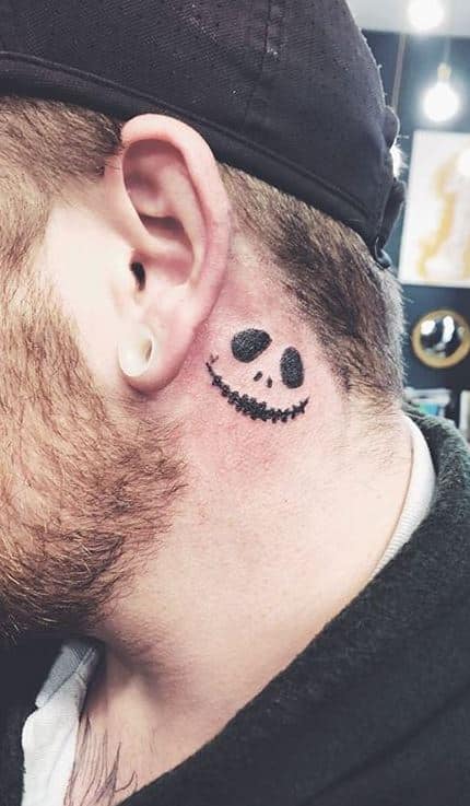 Smily face tattoo behind the ear for men