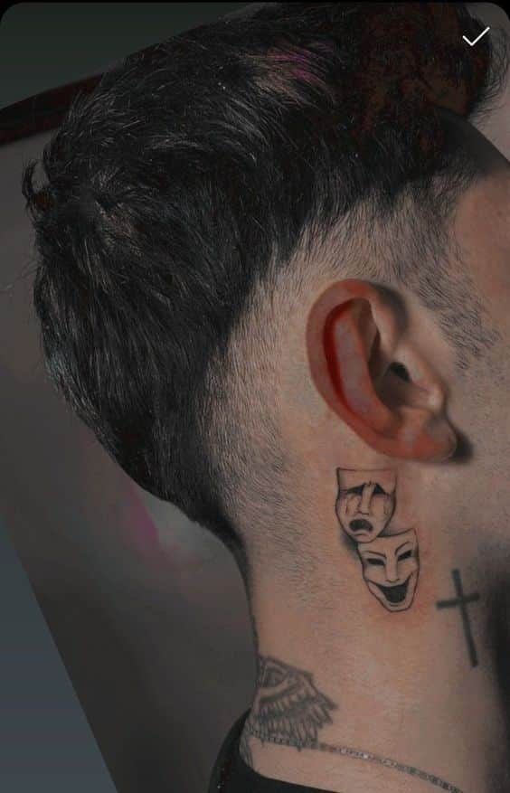 Mask faces behind ear tattoo for men