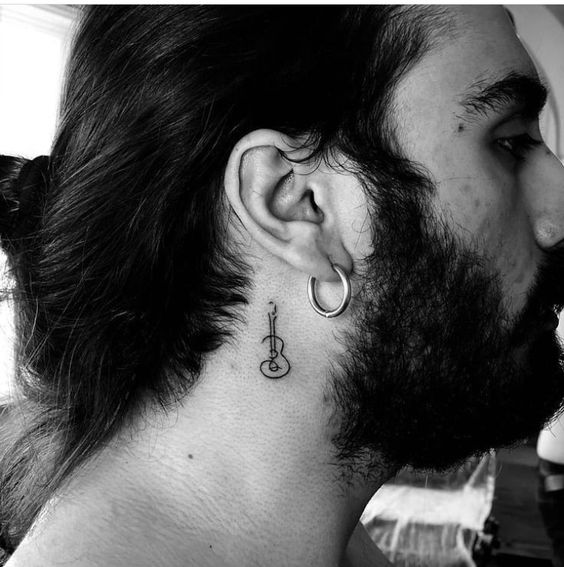 Guitar Design tattoo for men behind the ear