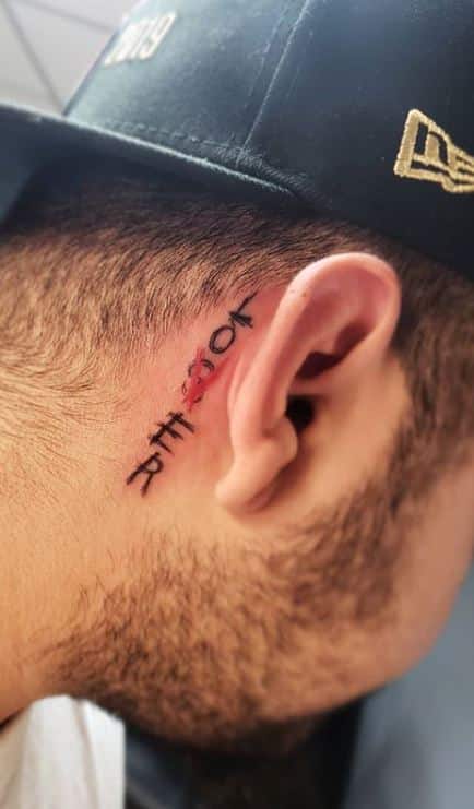 Loser Tattoo behind the ear