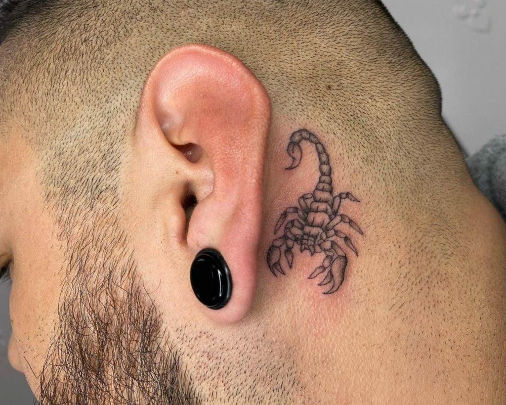 Small scorpio tattoo behind ear for men