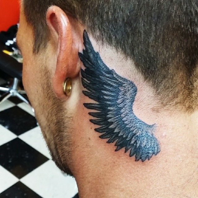Big wings tattoo behind ear