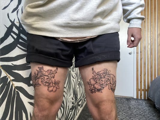 flowers on both Above Knee Tattoo design