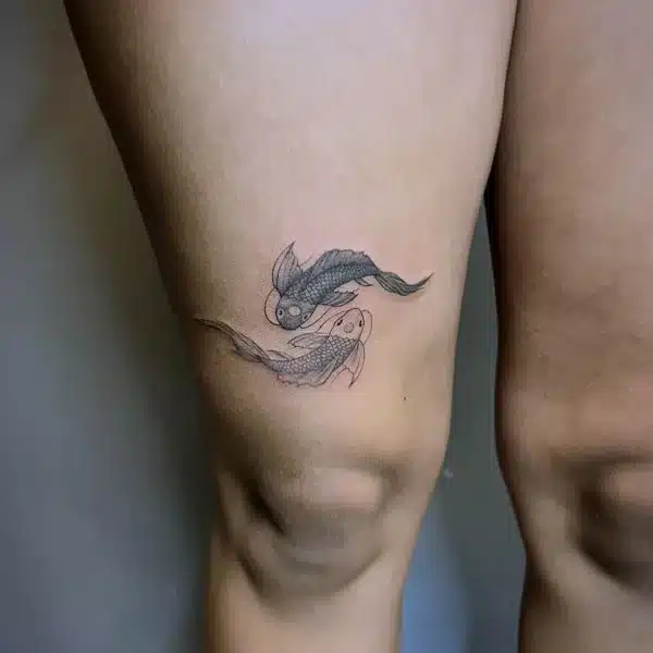 Two Fish above Knee Tattoo Design