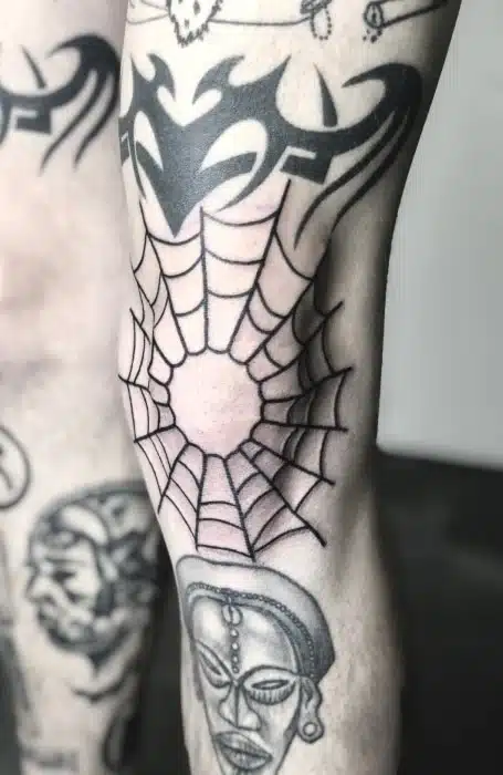Spider web above knee Tattoo