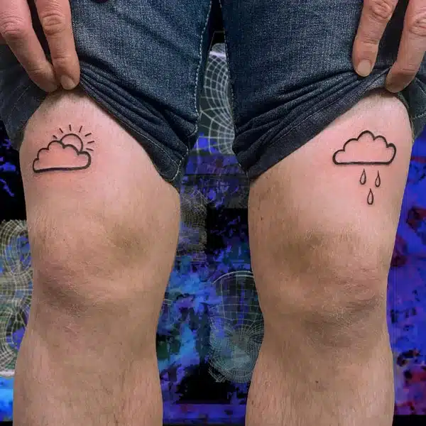 Clouds above knee tattoo