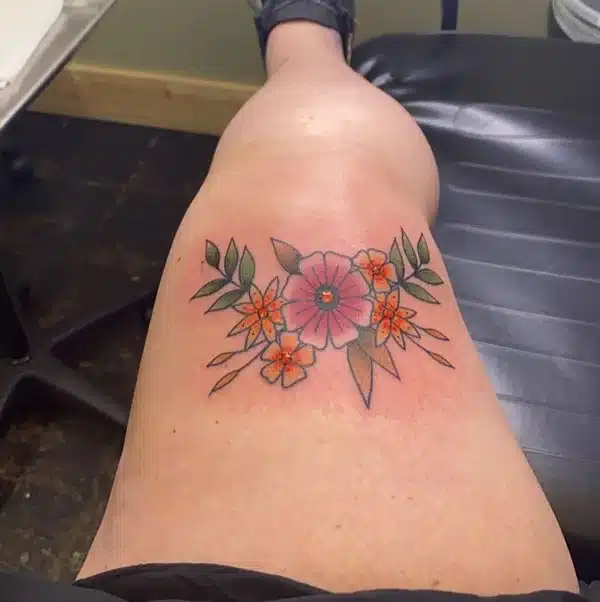 Colourfull flower Above knee Tattoo Design