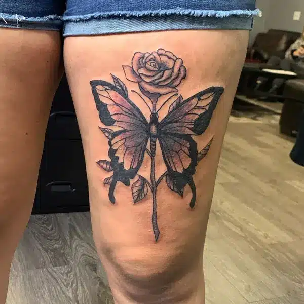 Butterfly and flower above knee Tattoo