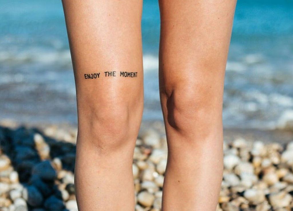 Enjoy the moment above knee tattoo design