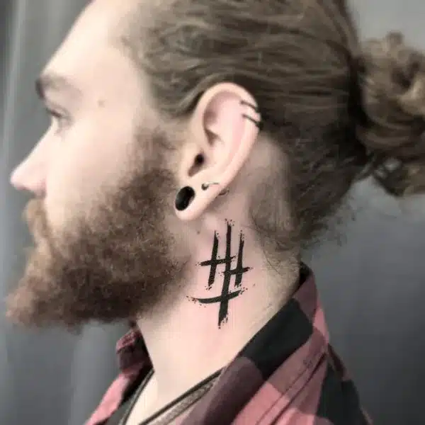 3 Cross Tattoo behind the ear for a men with pony tail