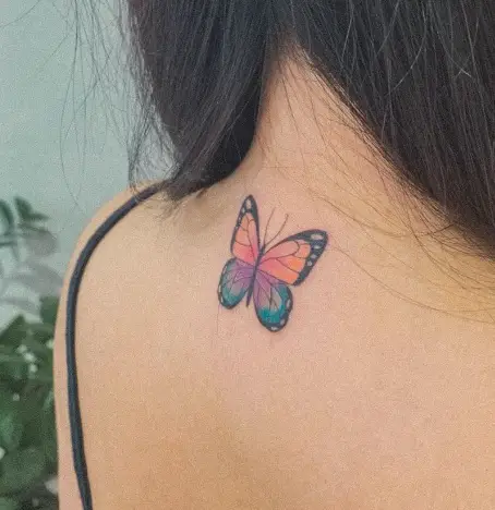 Colorful butterfly tattoo on girl's back