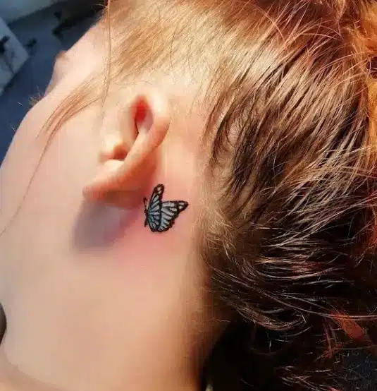 Small Butterfly tattoo on girl behind ear