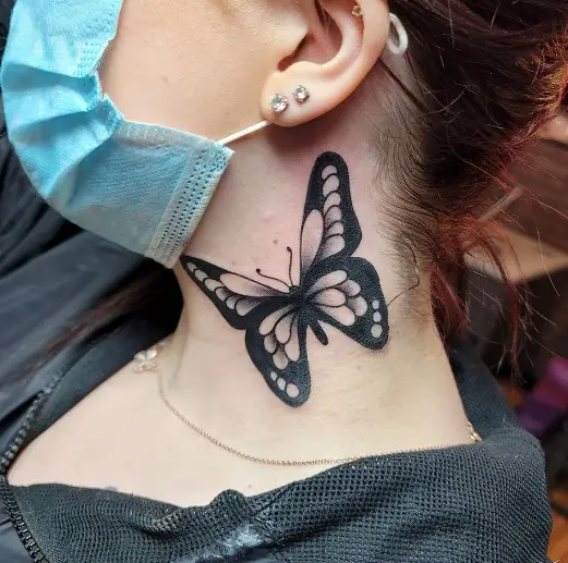 Girl wearing mask with butterfly tattoo on neck