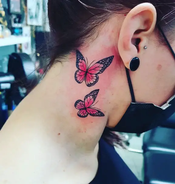 Red and black 2 butterflies on Girl behind ear