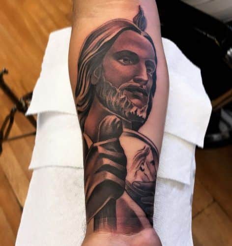 Redish San Judas Tattoo on Forearm