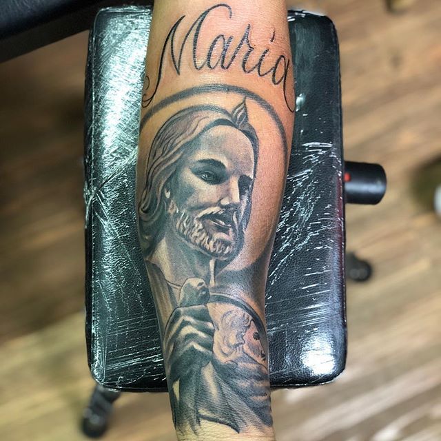 Maria written with San Judas Tattoo on Forearm