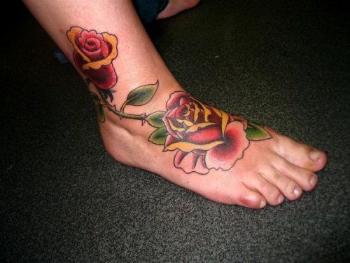 red, black and green inked Rose Tattoo on foot and ankle