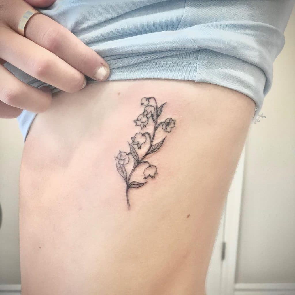 small branch of flower side belly tattoo for girls