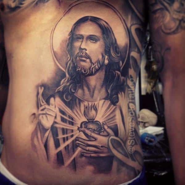 San Judas Tattoo on side belly for girls