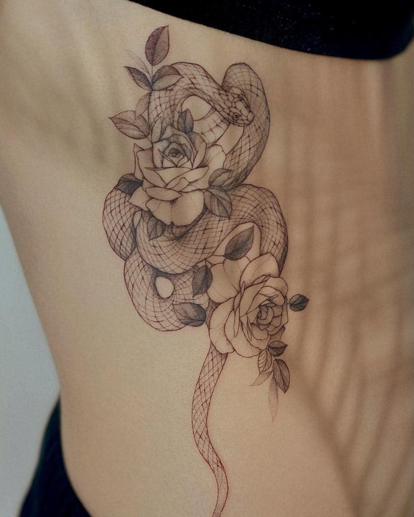 sneak in flowers side belly tattoo for girls