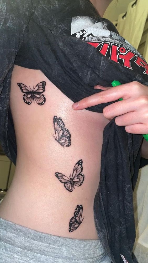 Elegant butterflies tattoo on side belly of girls