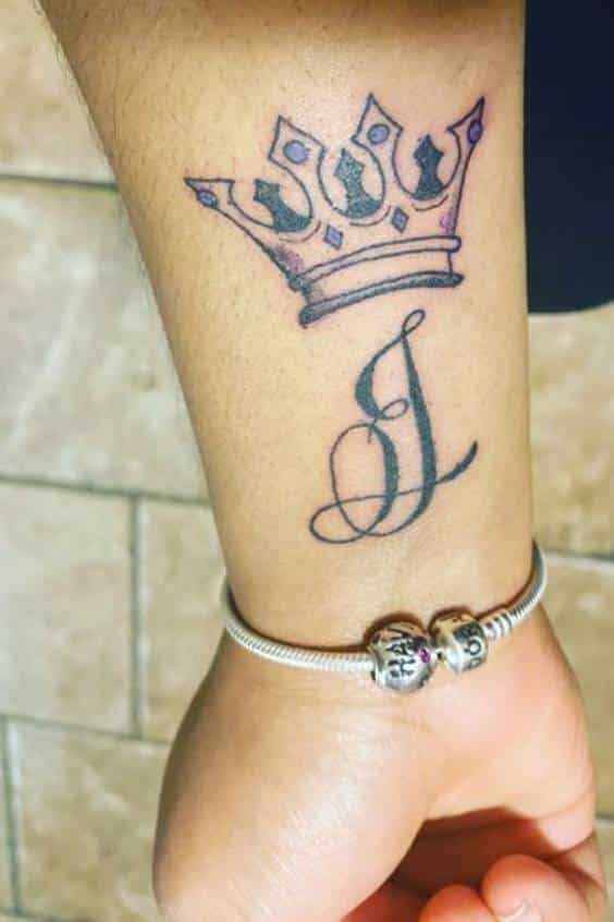 queen crown wrist tattoo
