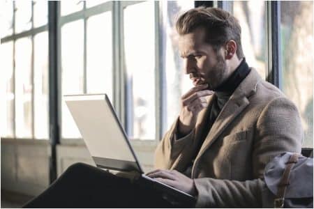 Businessman using laptop learning about the importance of customer journey automation