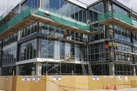 The New Face Of Commercial Makeovers: How Smart Owners Turn Renovations Into Long-Term Returns  Modern commercial building exterior under renovation.